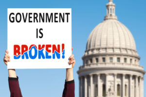 Protestor Holdingup Government Is Broken Sign Picture Id180745031 2929155077